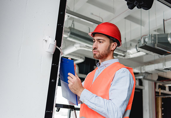 Man setting up a commercial alarm system in Broward County