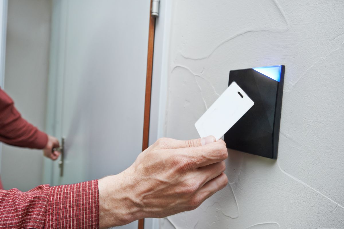 Hands Holding Key to Access Control Systems in Pompano Beach, FL