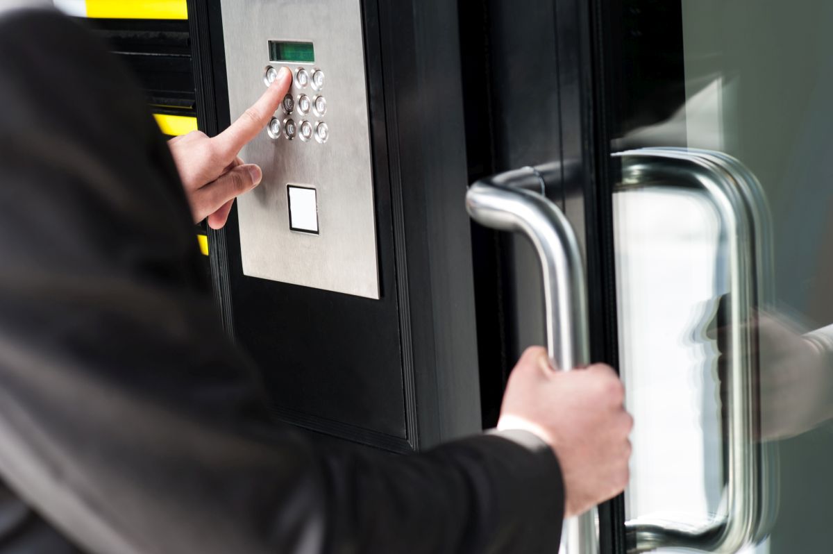 Man Opening Door with Access Control Systems in Pompano Beach, FL